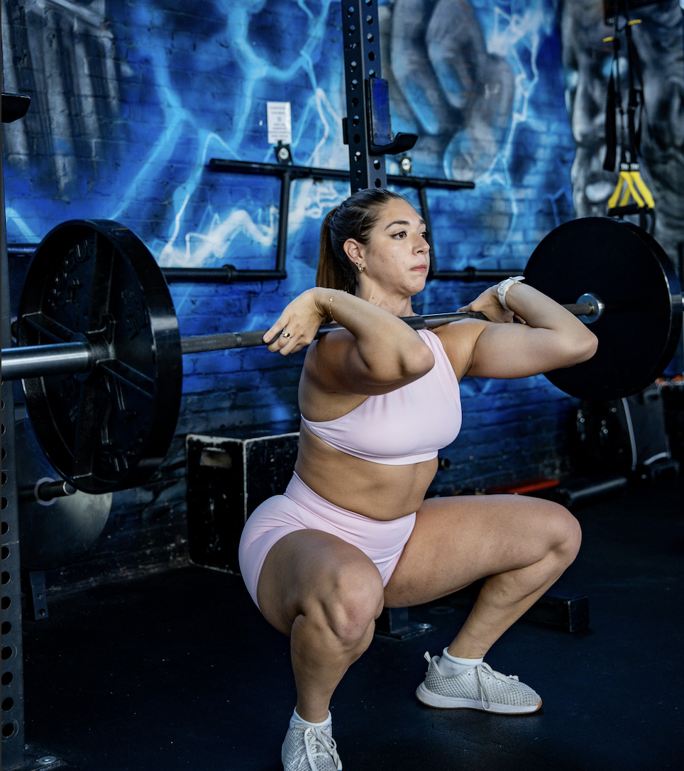 Madison Gold performing a front squat in the gym